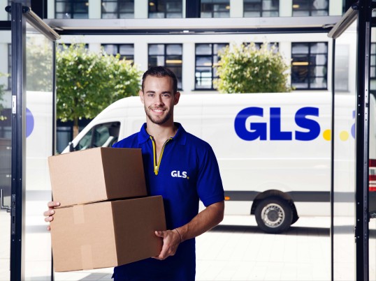 GLS driver delivering a parcel at home