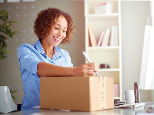 GLS employees preps a parcel for shipping