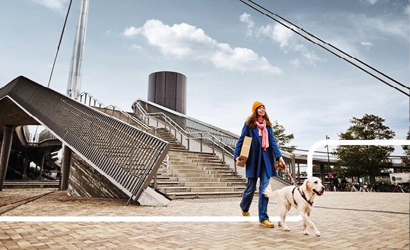 woman walking with parcel and dog