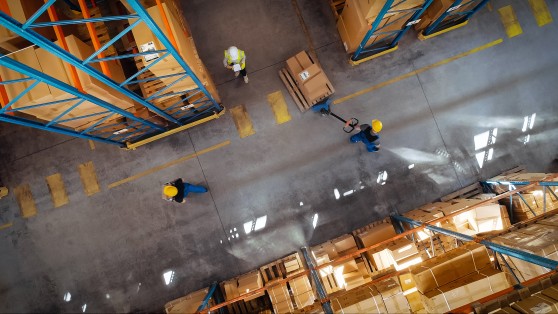 workers walking down a warehouse walkway