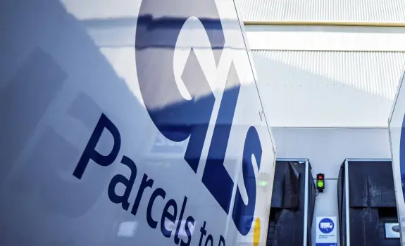 Two GLS trucks parked outside depot